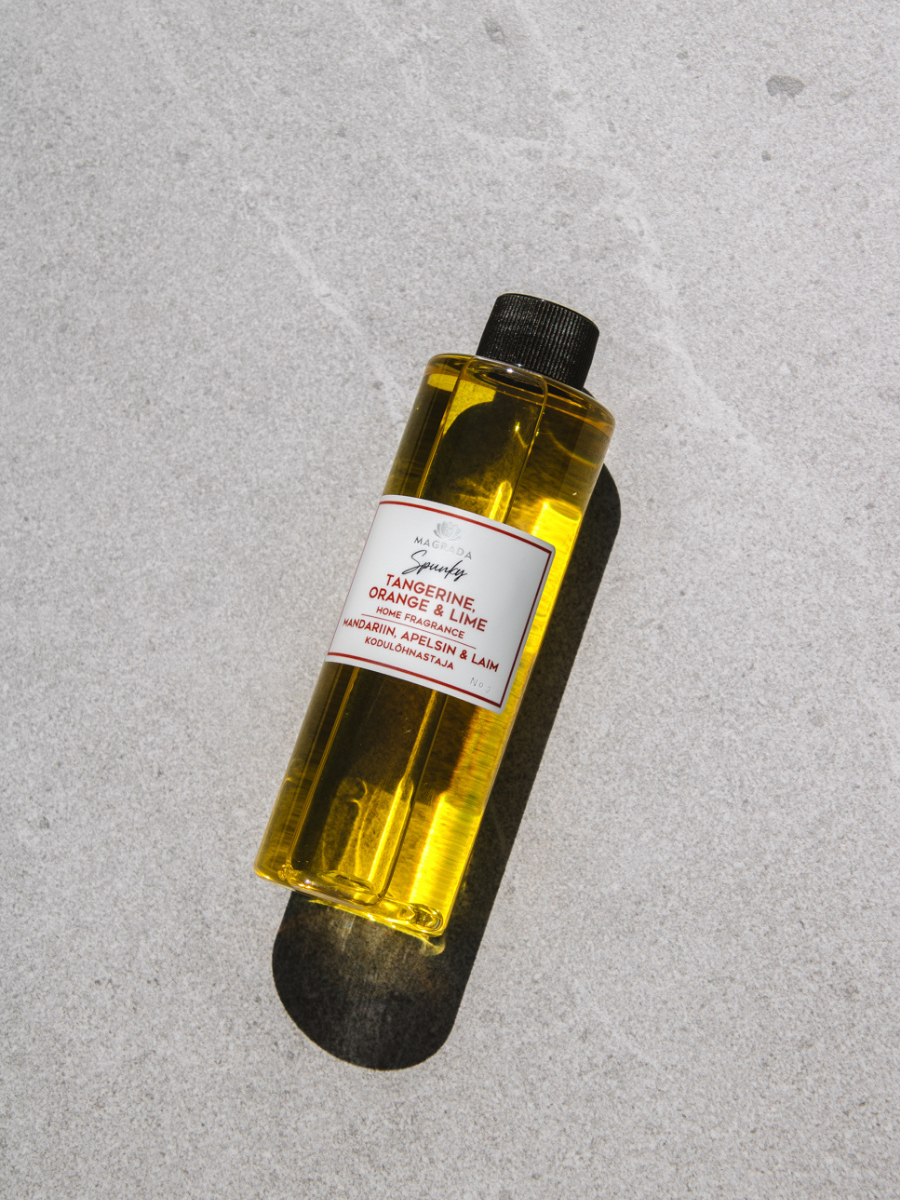 Magrada Organic Cosmetics tangerine citrus home fragrance bottle with orange and lime scent on gray surface