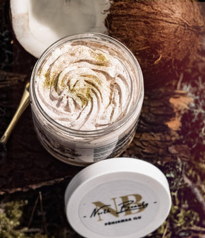 North Beauty body scrub in jar with creamy texture and coconut on rustic wooden background
