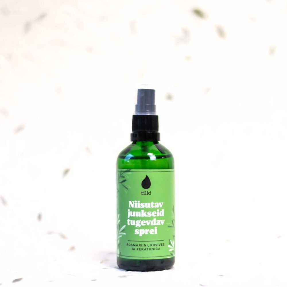 Tilk moisturizing hair spray in green bottle with black spray nozzle for hair care