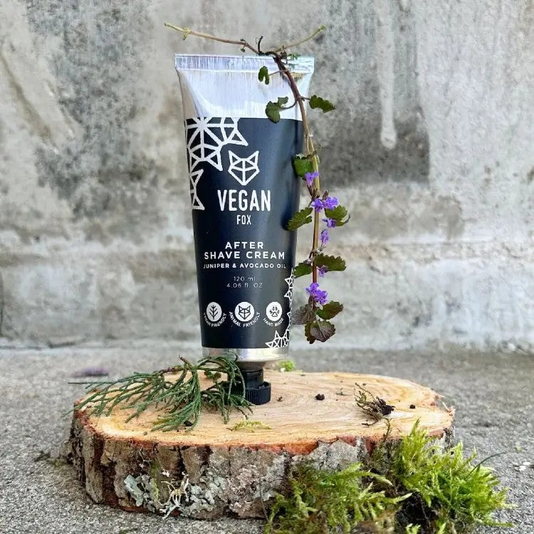 Vegan Fox vegan after shave cream tube with juniper and avocado oil on wooden slice with green moss