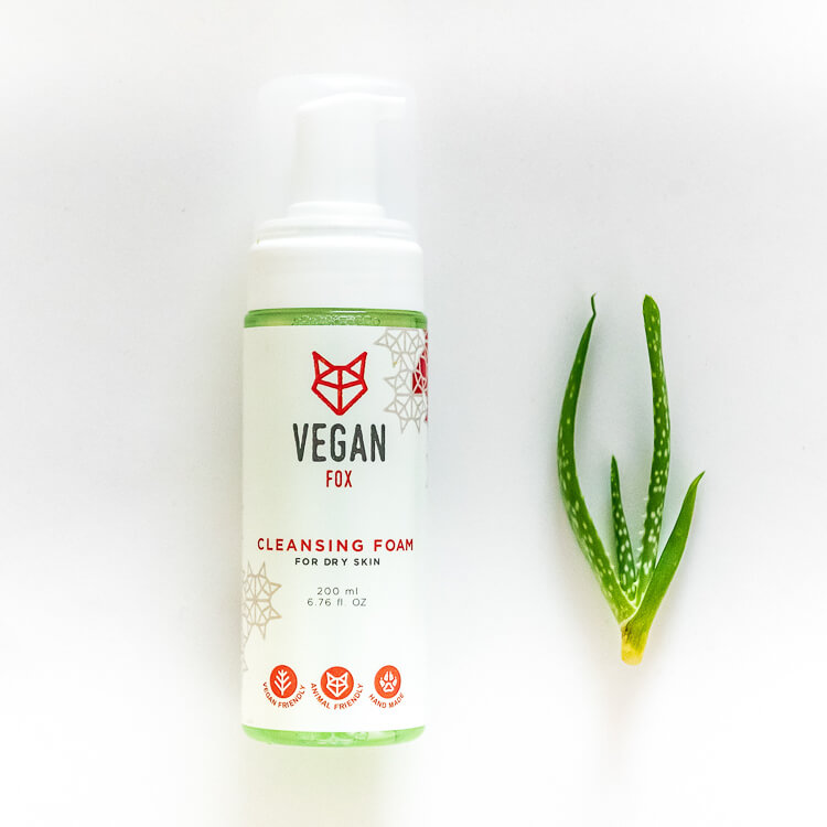 Vegan Fox vegan cleansing foam for dry skin in white pump bottle next to fresh aloe vera leaf