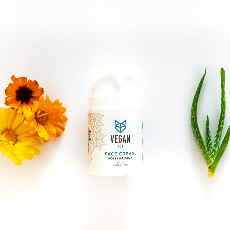Vegan Fox vegan moisturizing face cream bottle with yellow flowers and aloe vera plant on white background